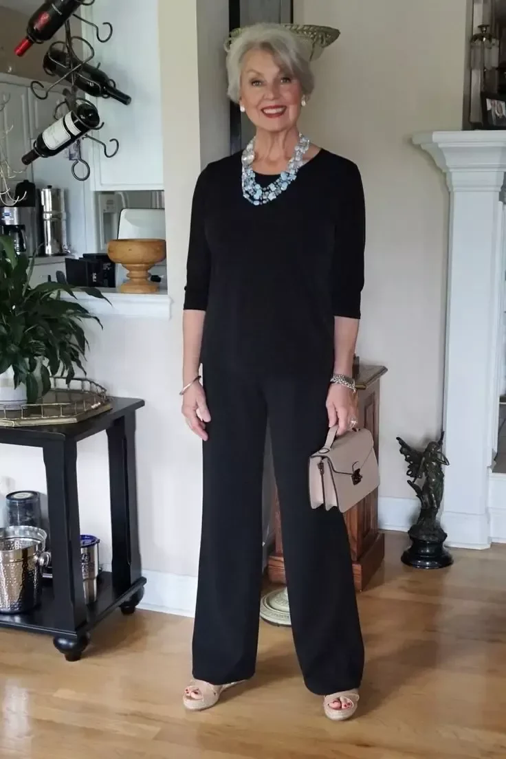 Black jumpsuit with statement necklace dinner outfit