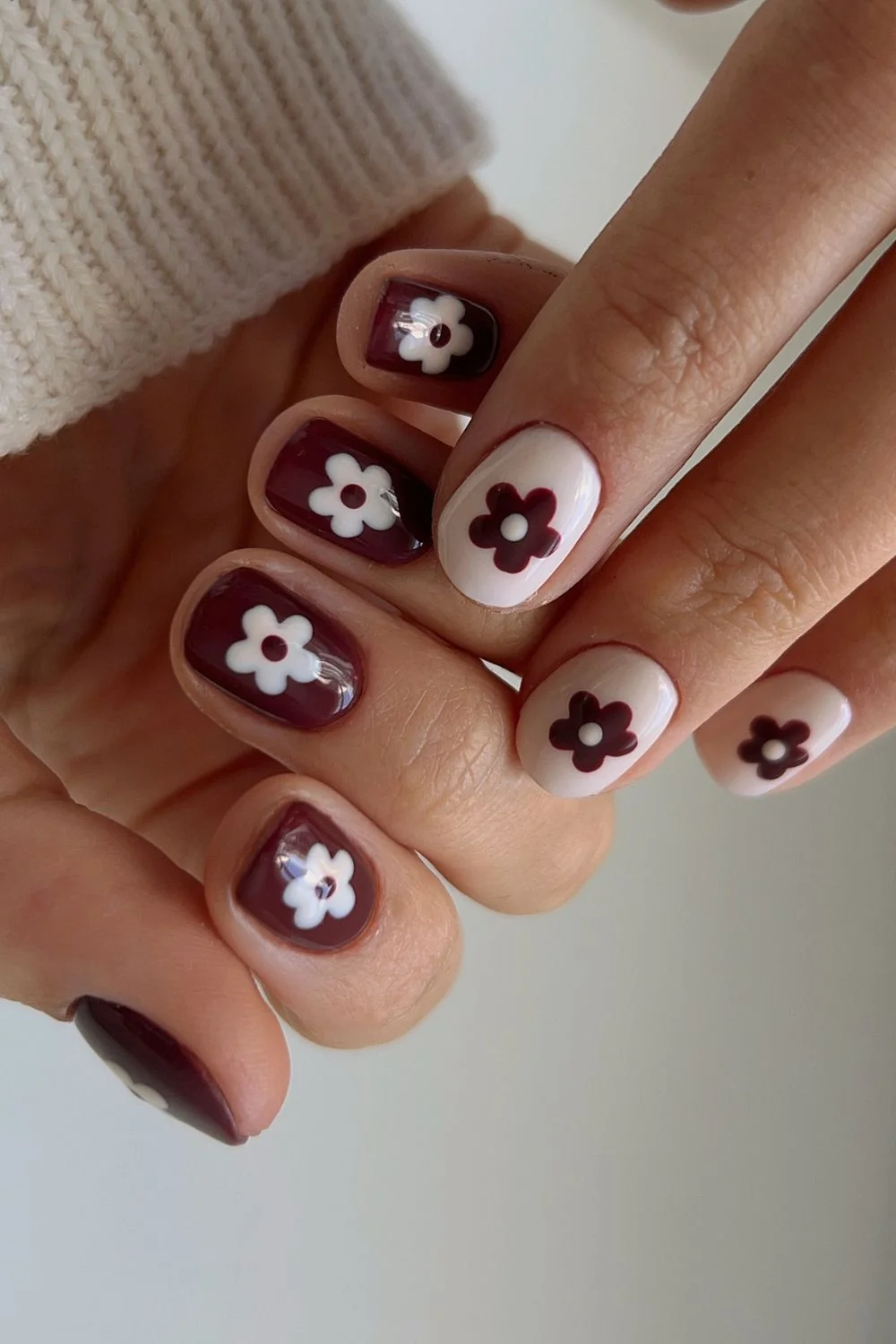 Easy fall nail ideas: dark plum nails with white flower art