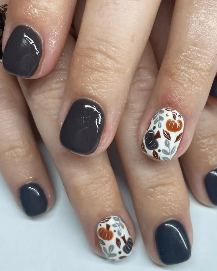 Easy fall nail ideas: glossy black nails with maple leaf accent