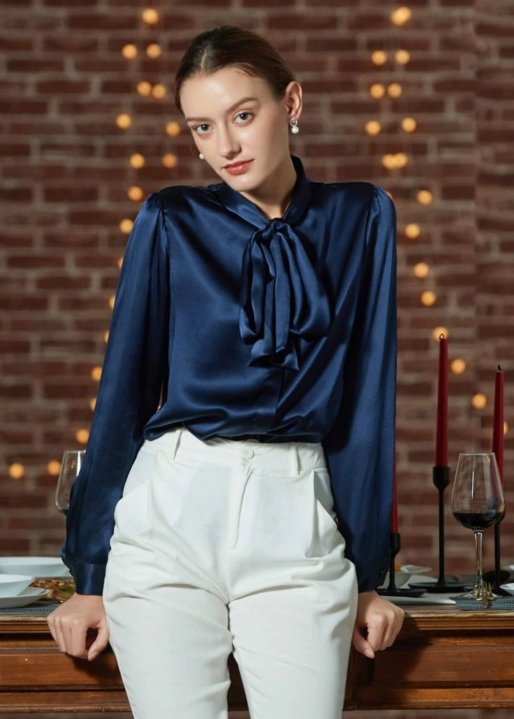 Navy satin bow neck blouse with cream wide leg trousers