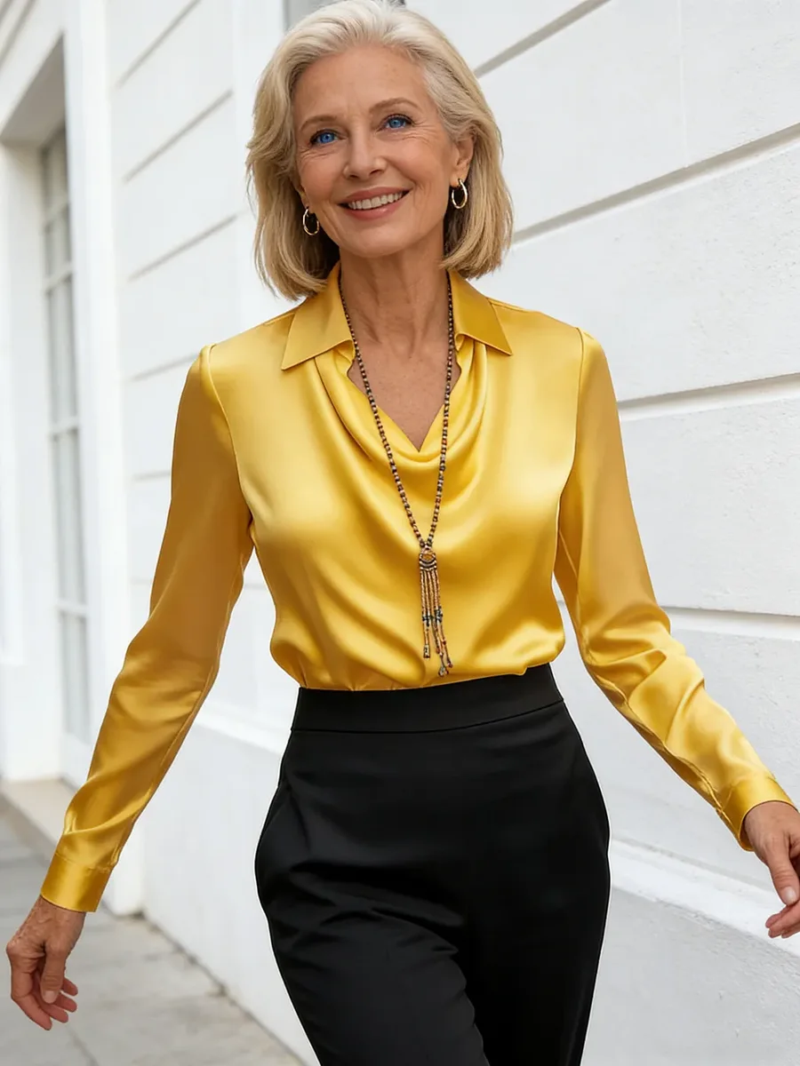 Mature woman in yellow satin shirt and black pants