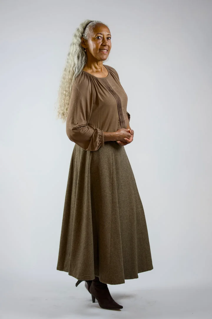 Mature woman in taupe blouse and olive maxi skirt