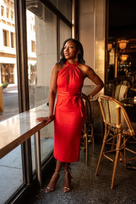 Red halter-neck midi dress at a restaurant
