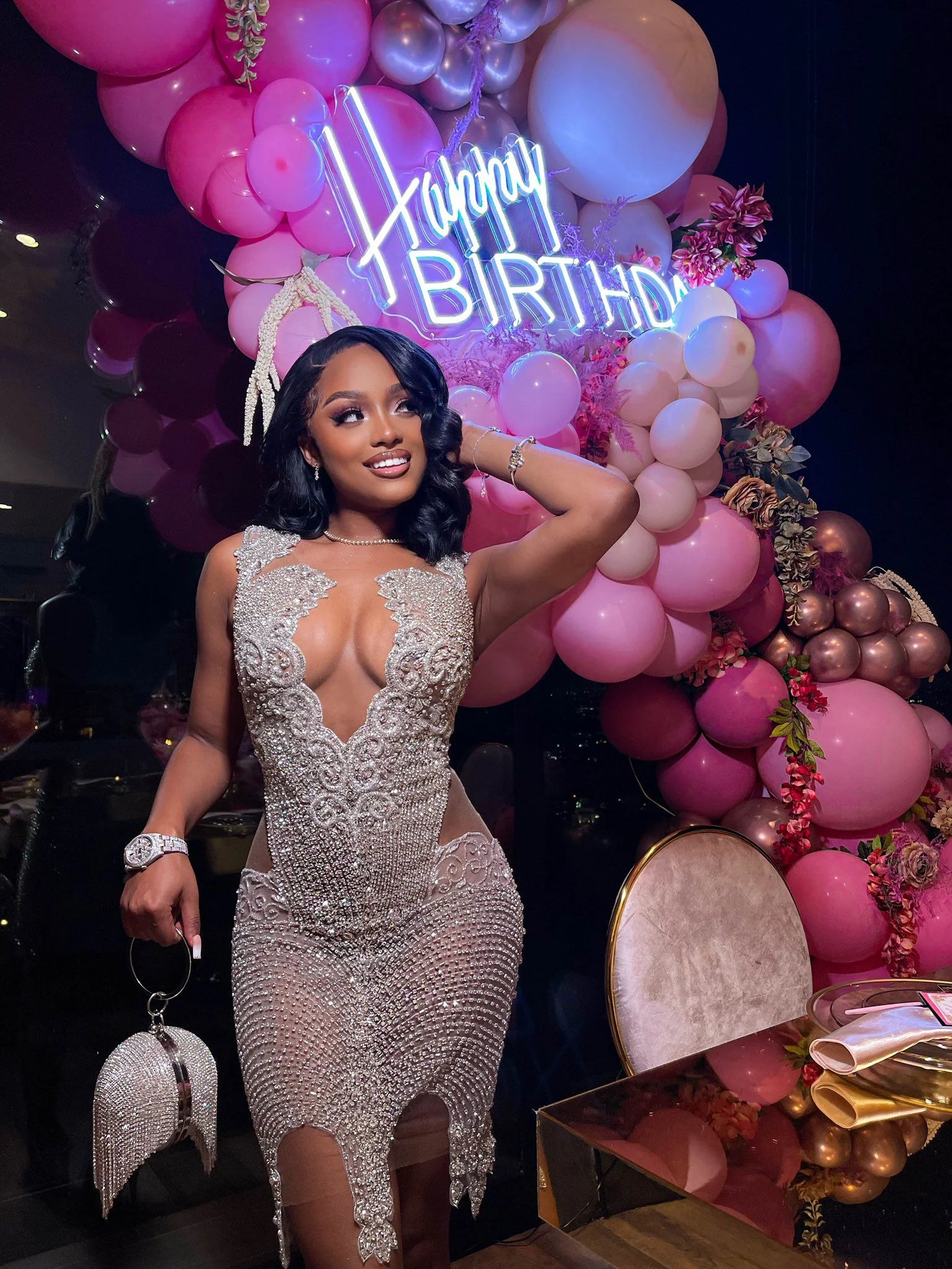 Silver sequin gown with happy birthday neon sign and balloons