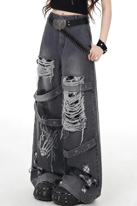 Goth outfit with jeans: black patch-detail jeans with off-shoulder top