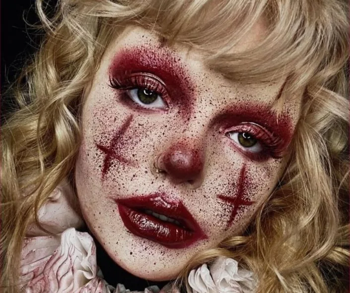 Bloody freckle clown makeup with red nose and stitched cheek