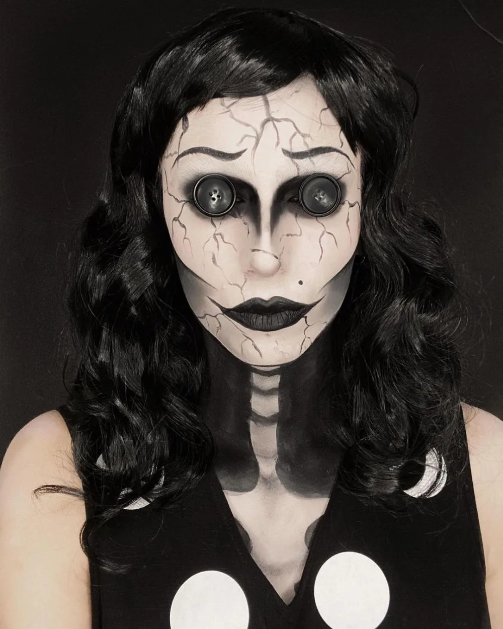 Cracked porcelain vampire makeup with white contact lenses
