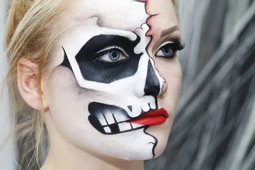 Half face skull makeup with natural glam side and red lips