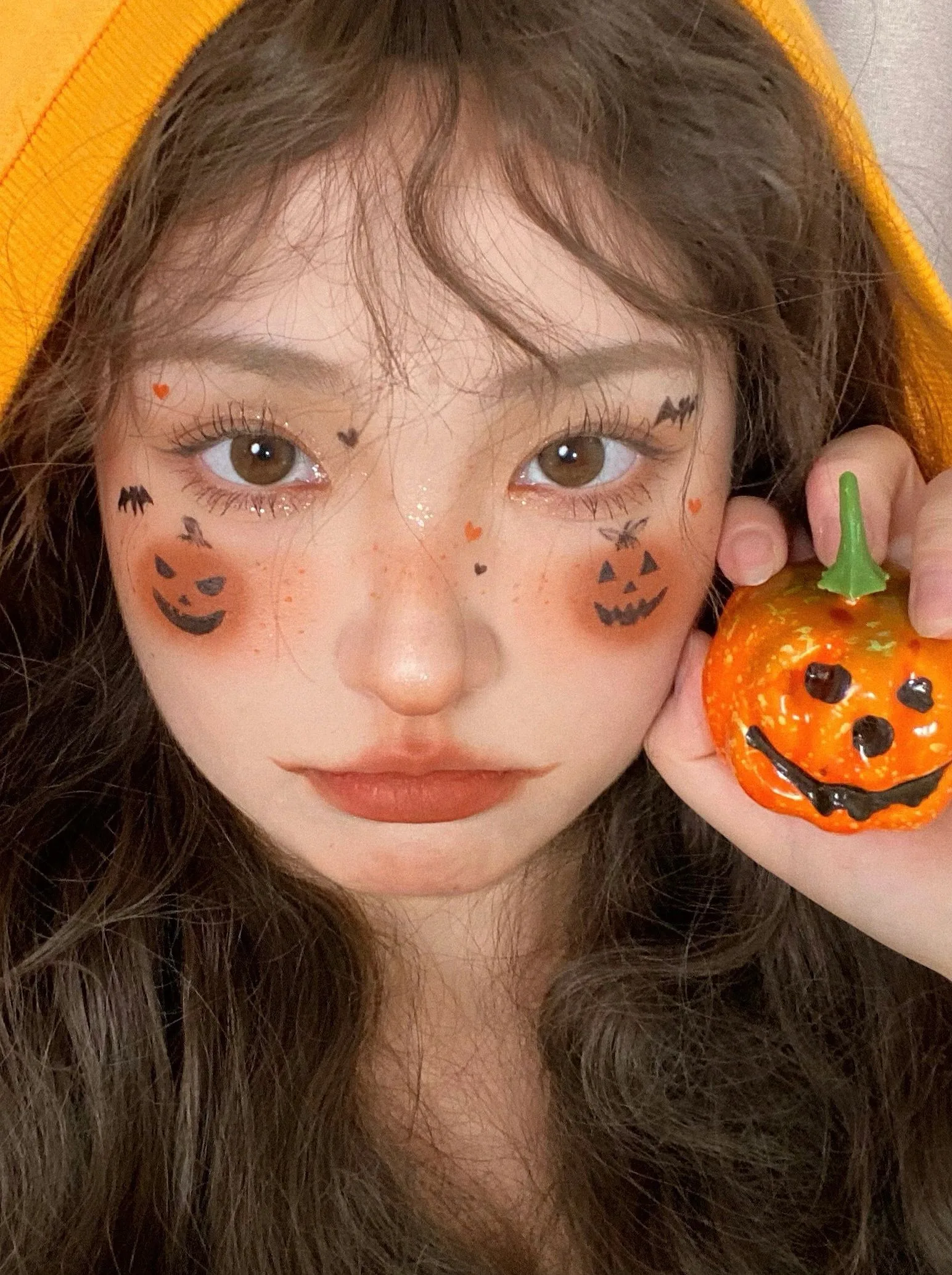 Pumpkin cheek scarecrow makeup with mini pumpkin prop