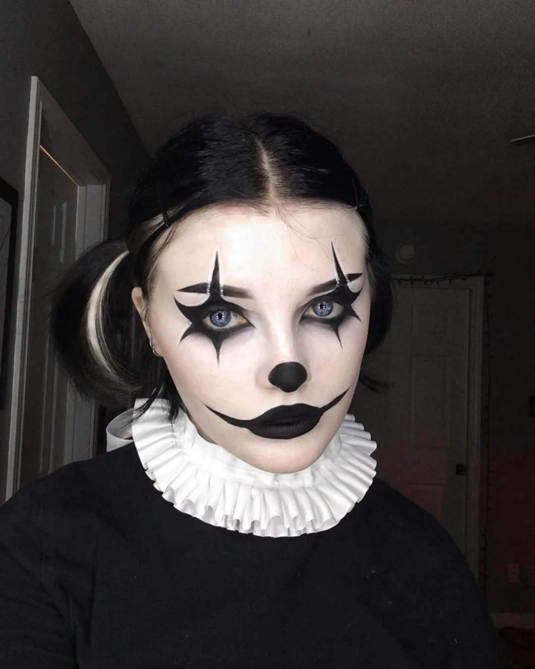 Vintage mime makeup with white face and black star eyes