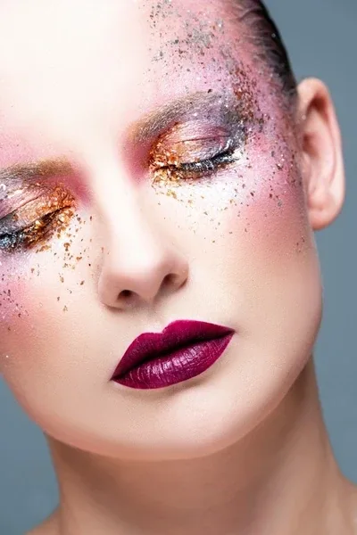 Glitter mermaid makeup with gold glitter lids and berry lips