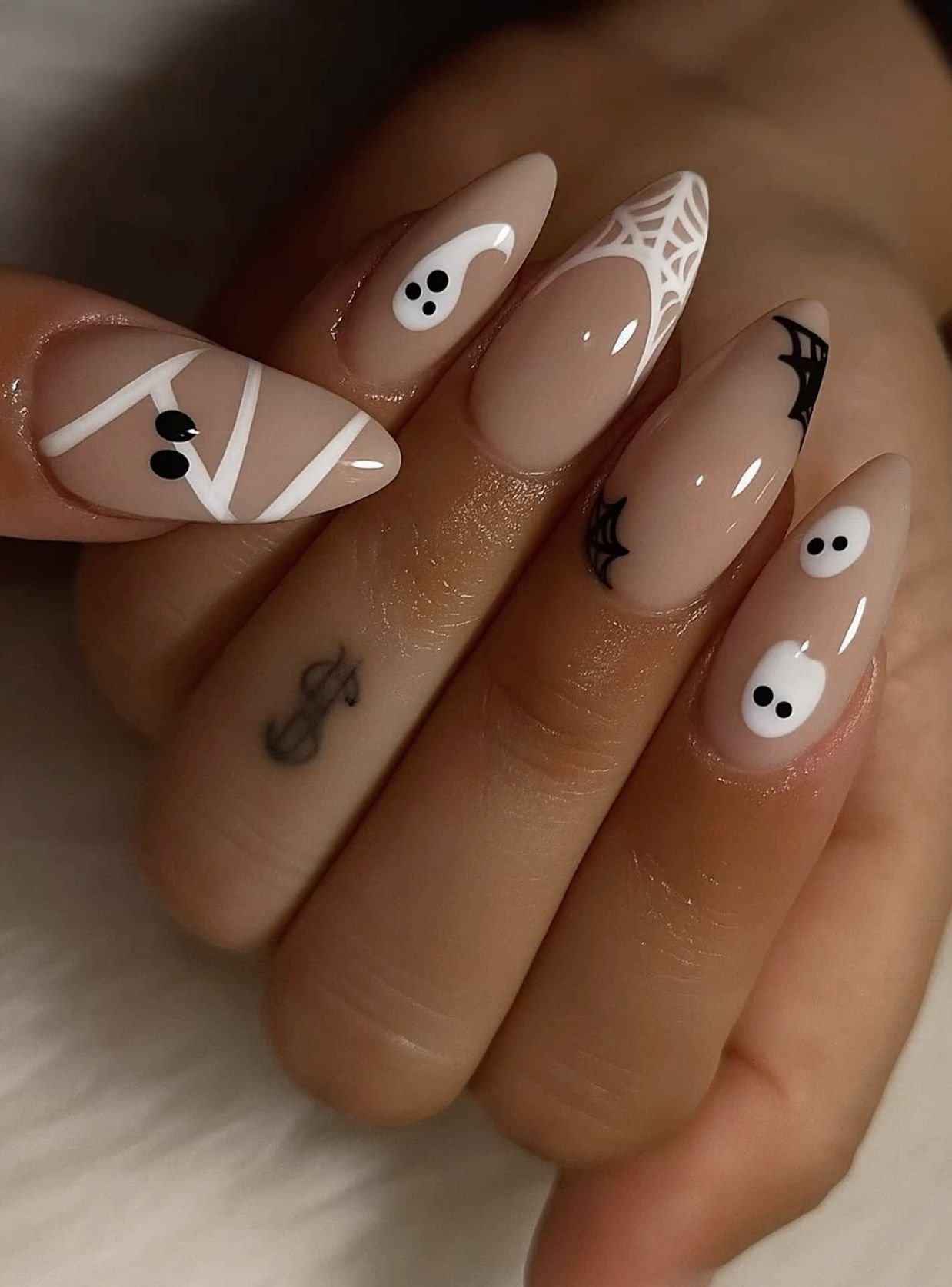 Halloween wedding nails: nude almond with tiny ghosts