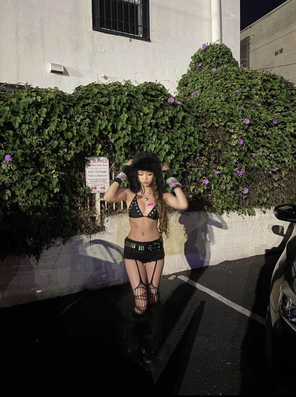 III points festival outfit: black bikini top and shorts with boots at night