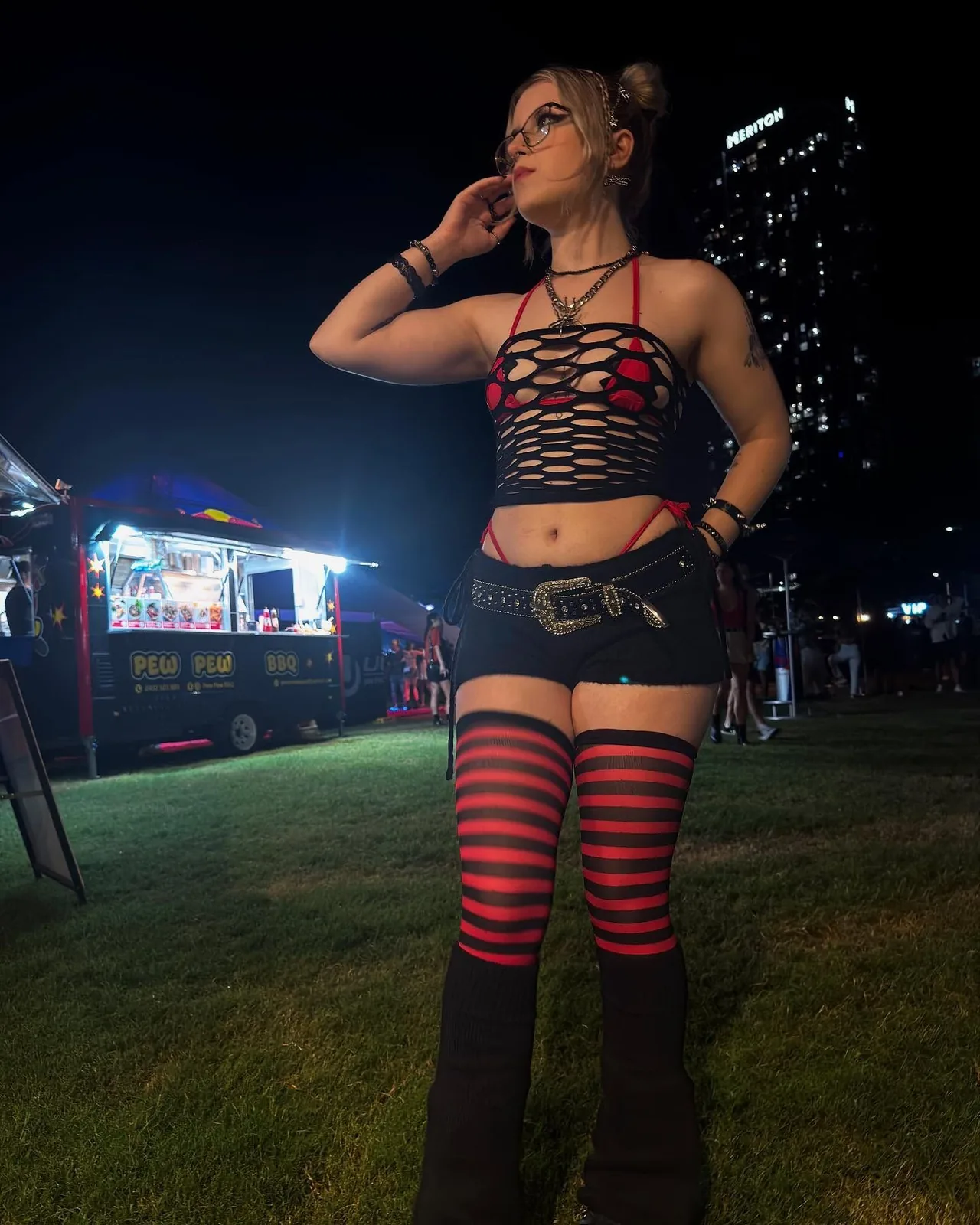 III points festival outfit: red-and-black striped thigh highs with a black top at a night festival