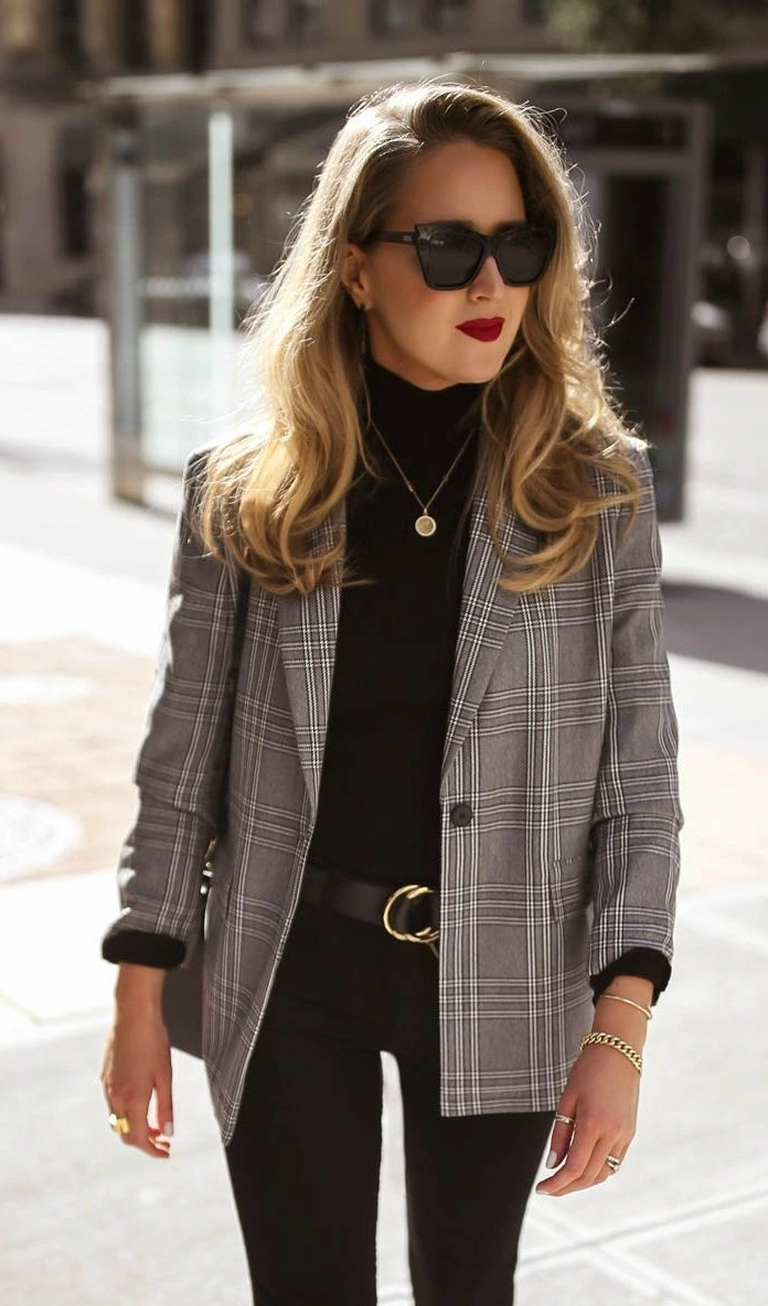 Petite woman wearing plaid blazer over black slim trousers for Thanksgiving