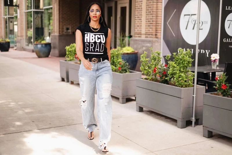 Black woman in a black HBCU grad tank top and ripped jeans