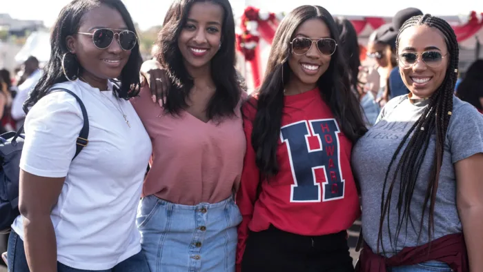 Group of Black women smiling together at an HBCU homecoming tailgate