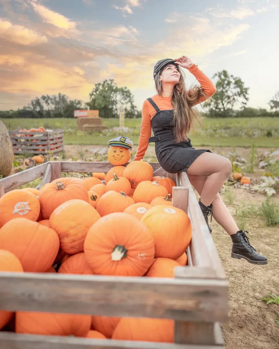 Pumpkin patch outfit: mustard overalls shorts with an orange sweater at the farm