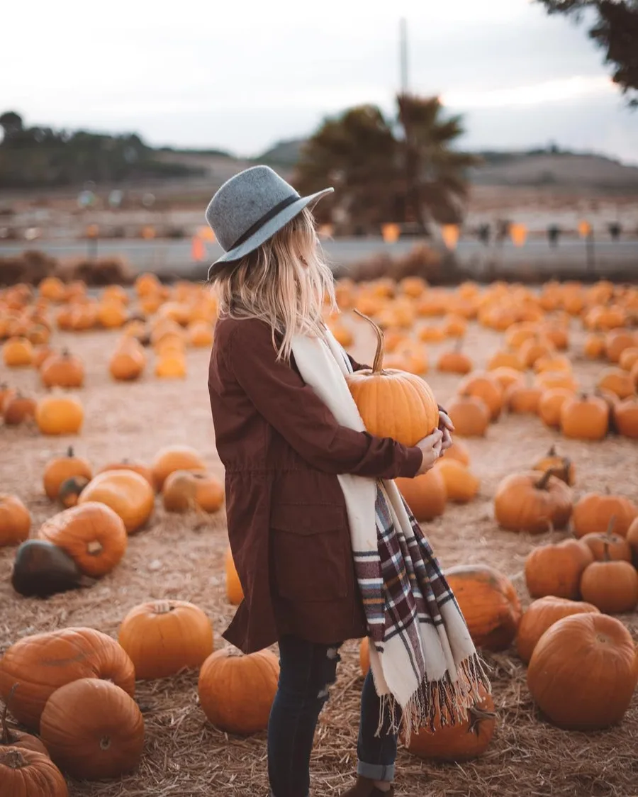 Fall pumpkin picking outfit: brown coat with a plaid scarf and gray hat
