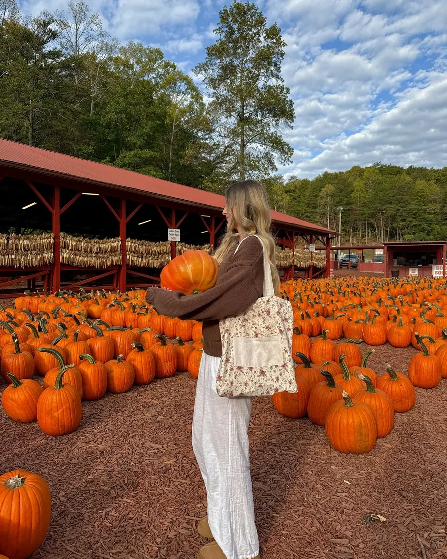 Pumpkin stand outfit: white midi dress with a woven tote at the market