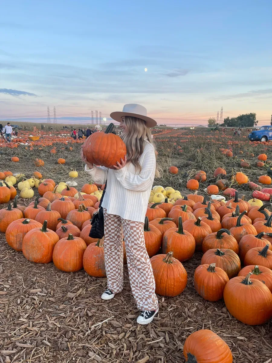 Pumpkin patch outfit: white top with patterned wide leg pants and a straw hat