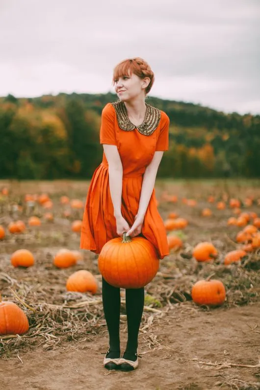 Cute pumpkin patch outfit: orange fit and flare dress with green tights