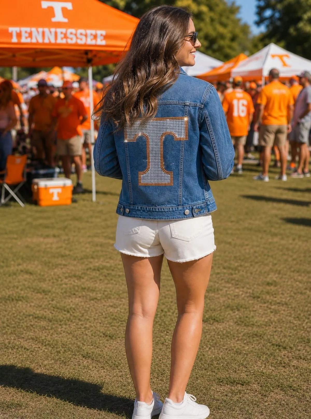 Woman wearing a Tennessee denim jacket at a tailgate