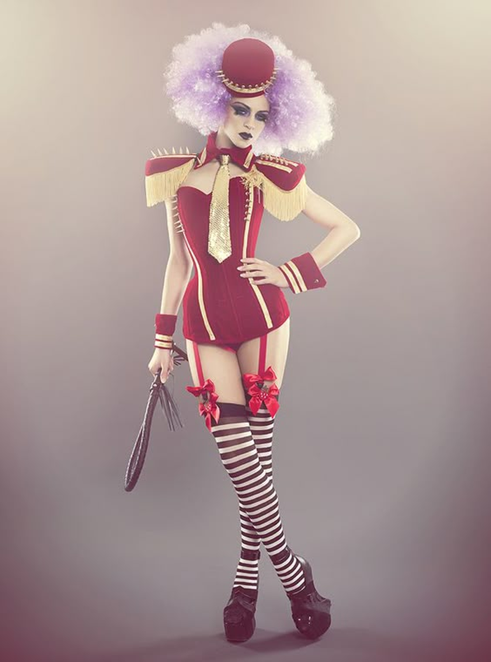 Woman in red and gold ringmaster showgirl costume