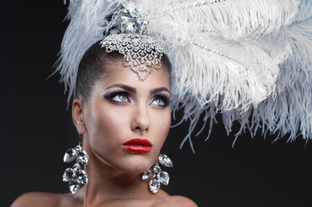 Woman wearing white feather showgirl headband portrait