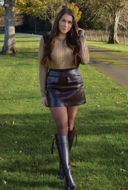 Camel chunky sweater with brown leather mini skirt and tall boots, fall date night outfit