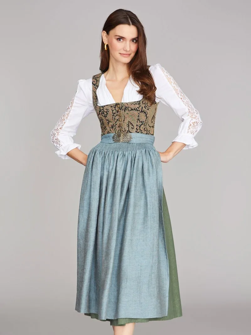 Woman in a brocade bodice dirndl with a dusty blue apron and lace sleeves