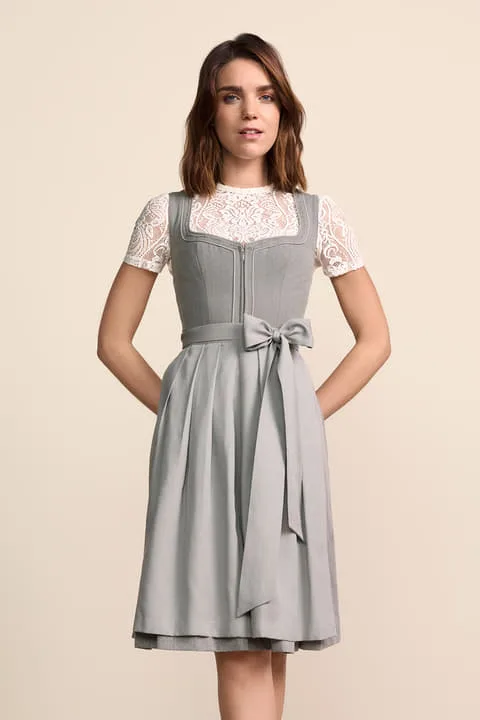 Woman in a cool grey dirndl with a lace blouse