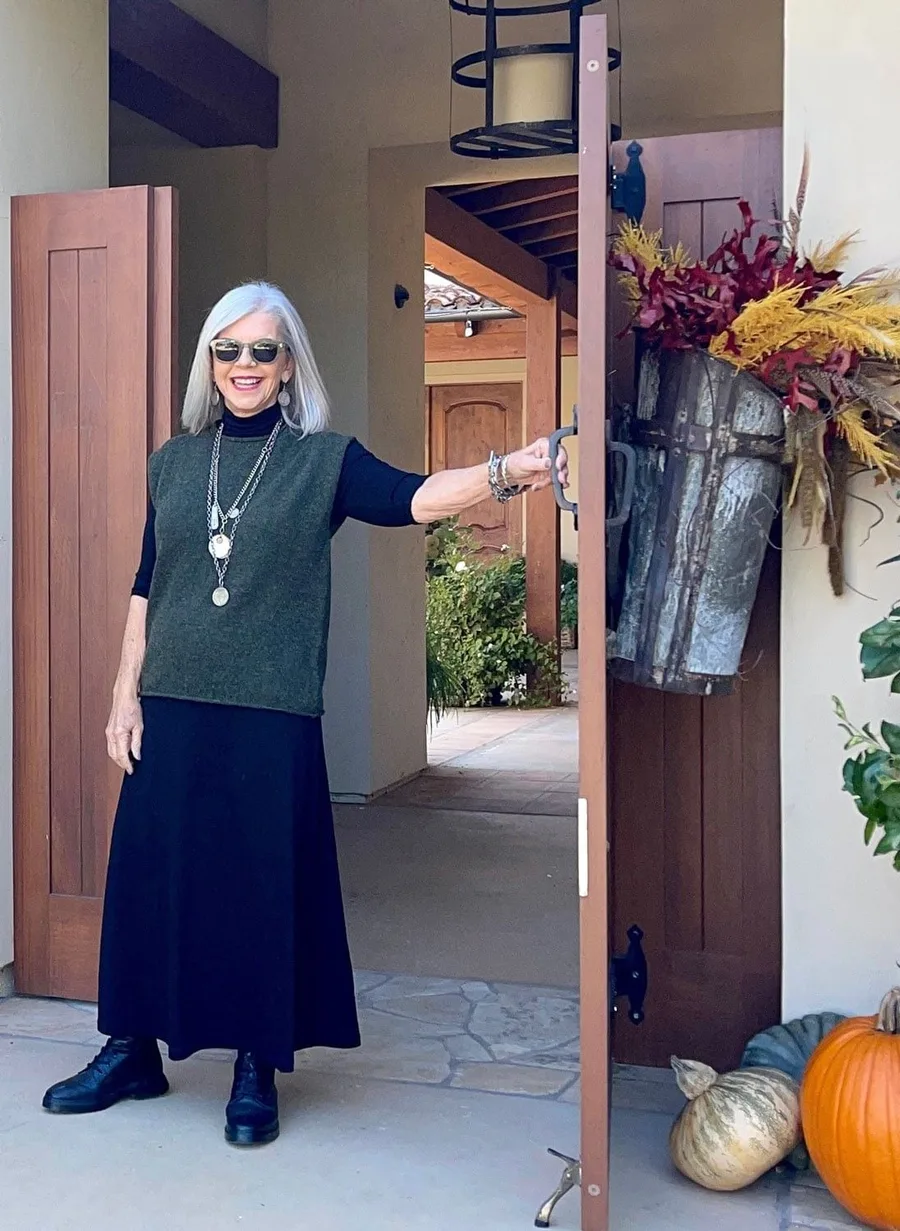 Fall doorway outfit: green vest with a long navy skirt