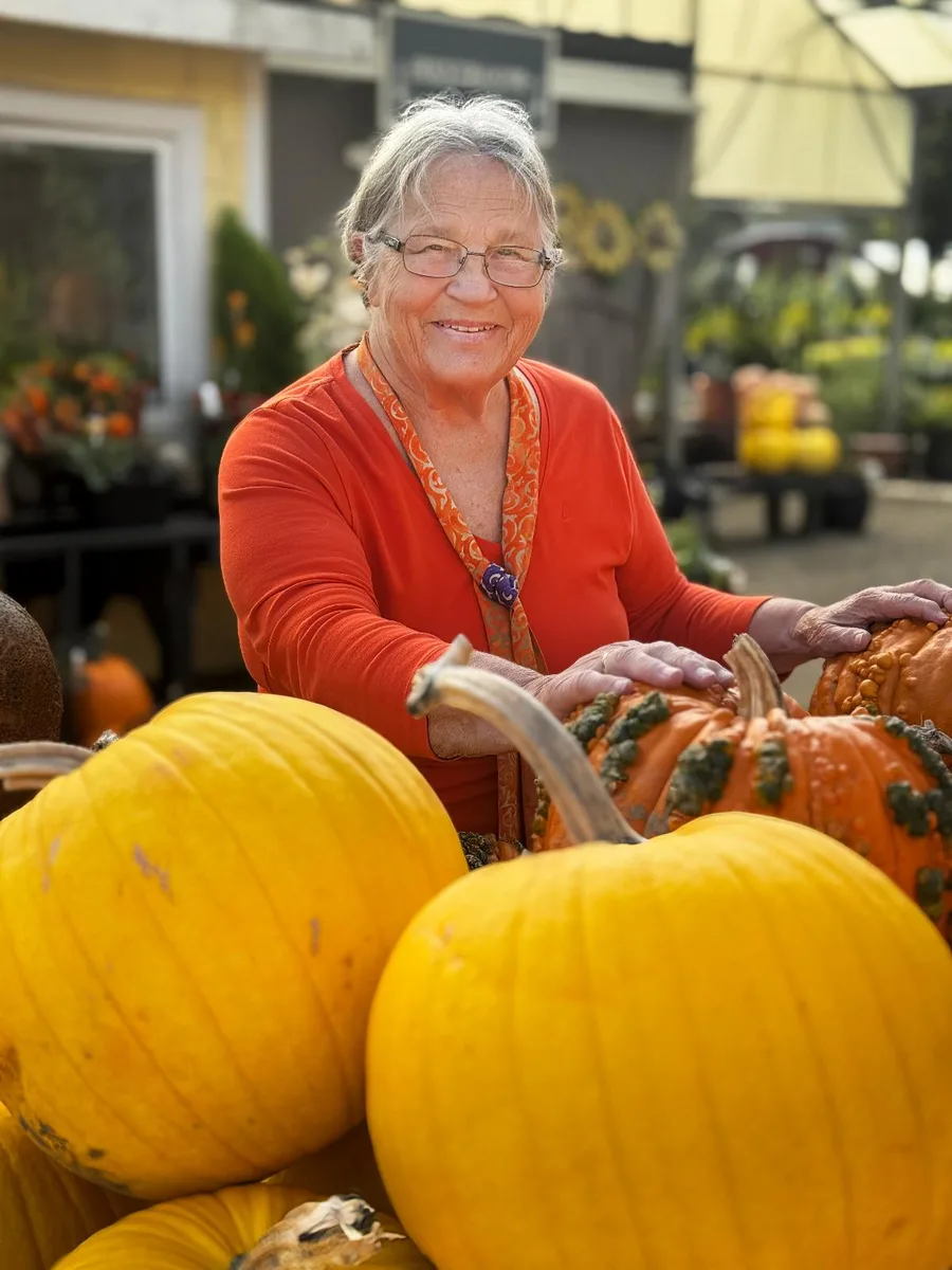 Pumpkin patch outfit: bright orange top with pumpkins at the farm stand