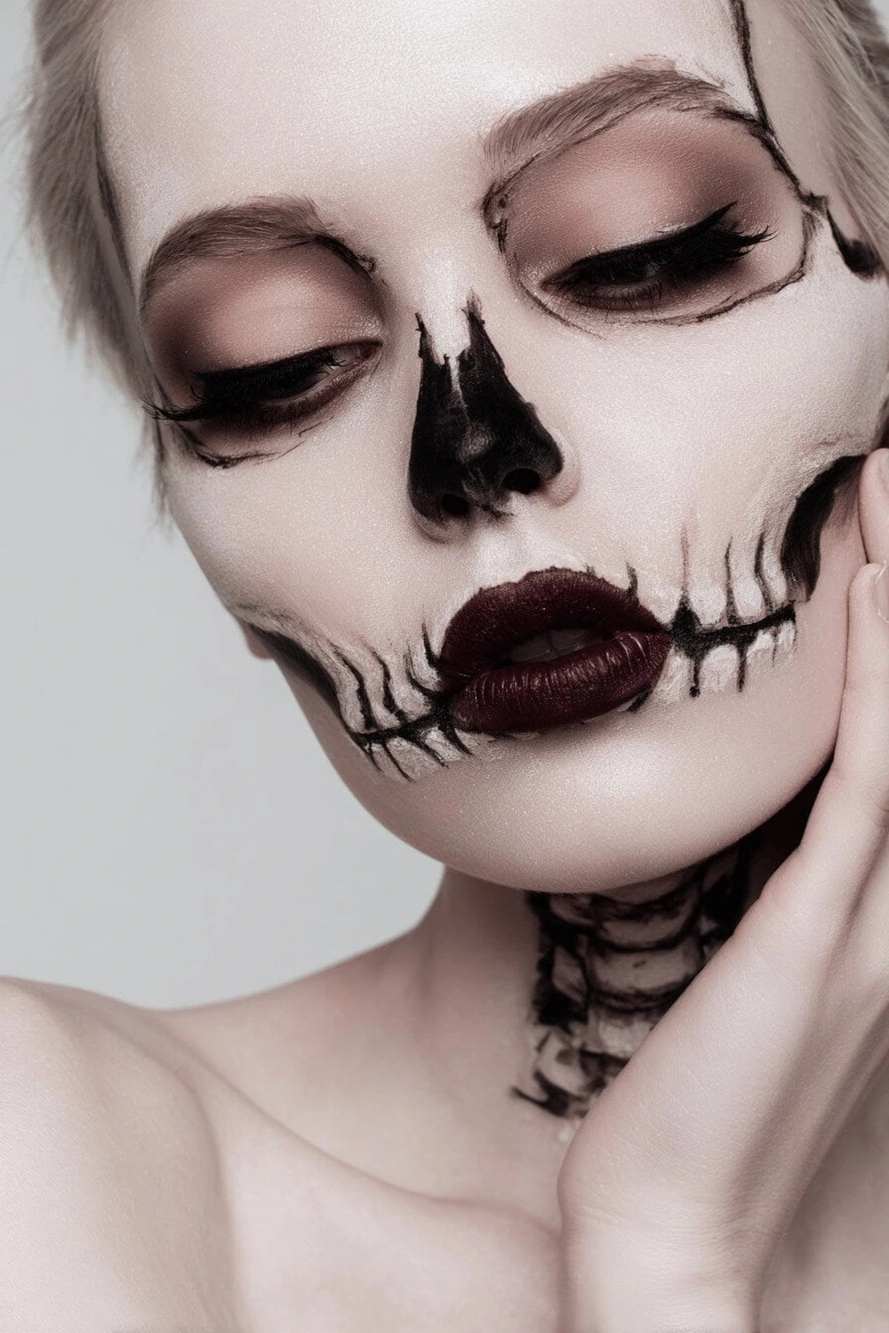 Woman with skeleton face paint Halloween makeup