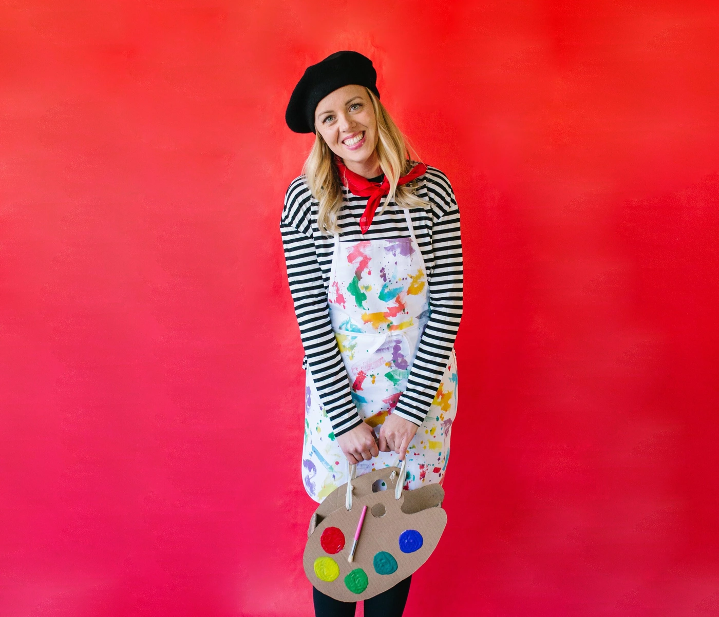 Woman in artist painter costume with beret and paint palette