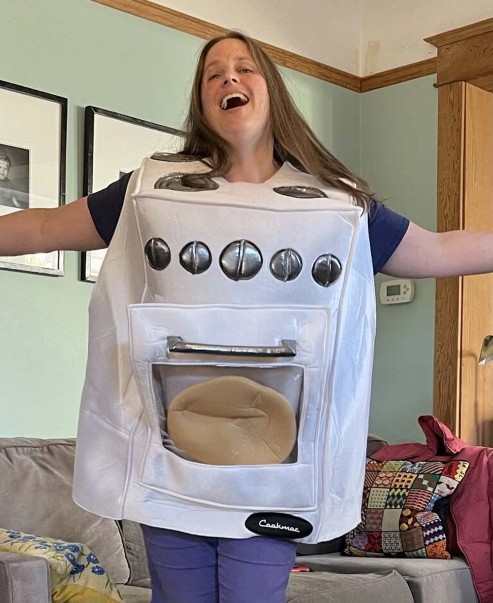 Woman in funny chef costume with kitchen tools