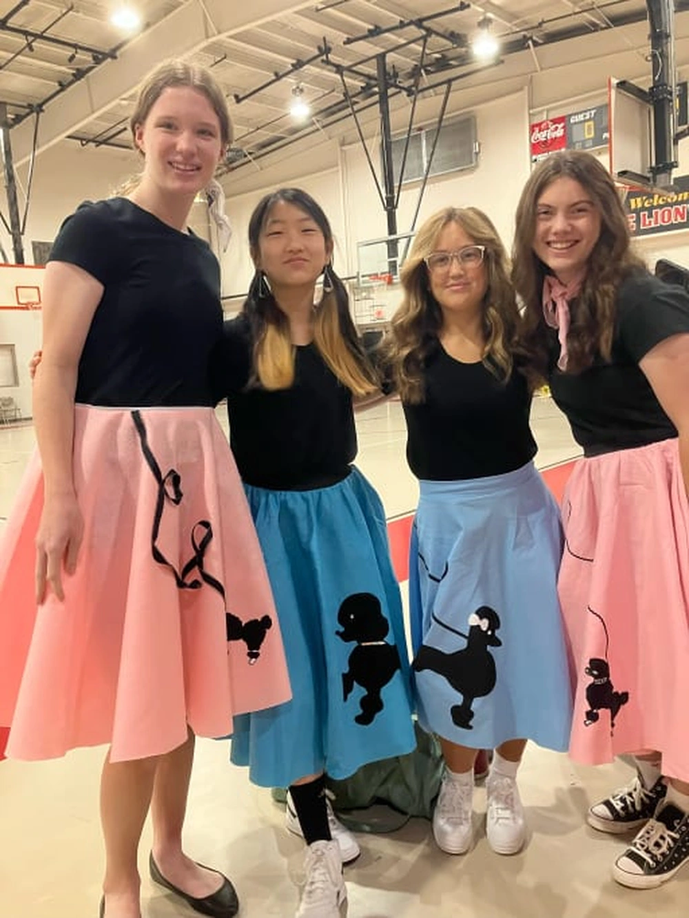 Teen girls wearing 1950s poodle skirts for spirit week