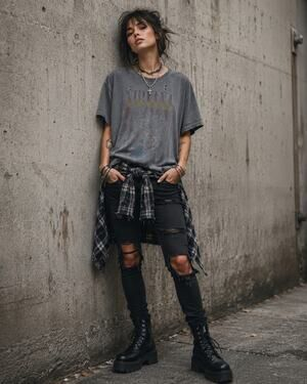 Woman in 90s grunge outfit with flannel shirt