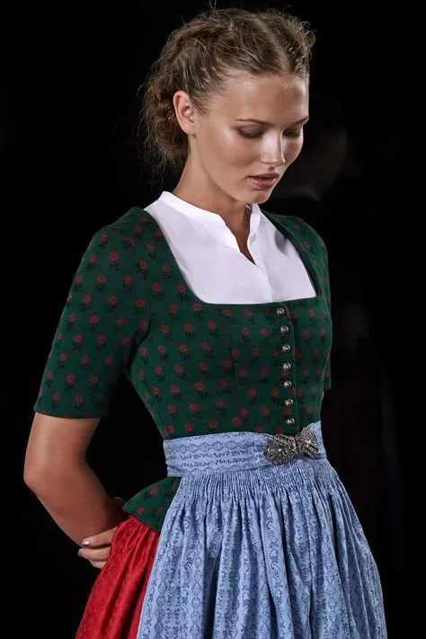 Young woman in a green dirndl with a blue apron