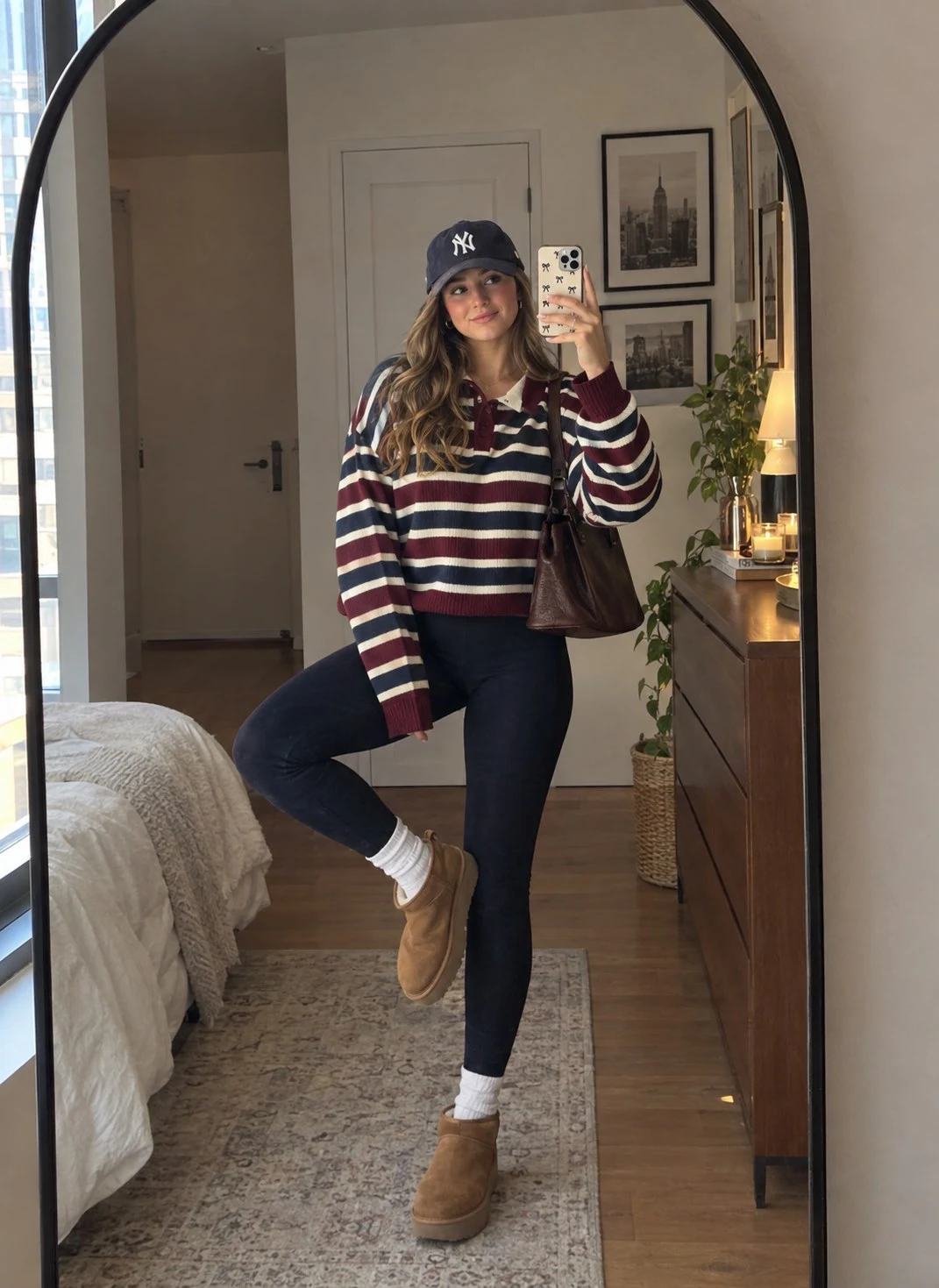 Striped sweater with black leggings and tan boots