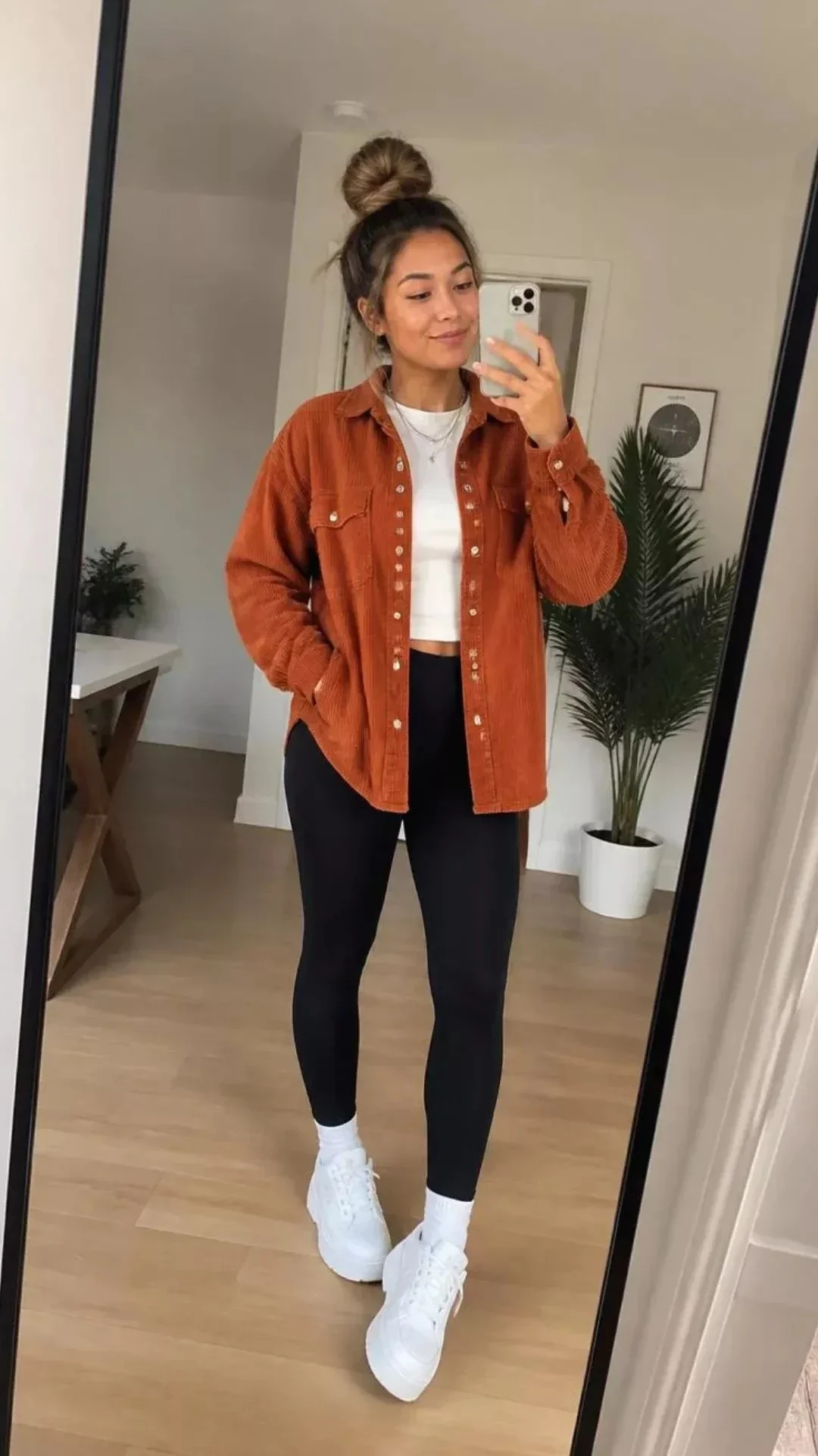 Rust corduroy shacket with black leggings and sneakers