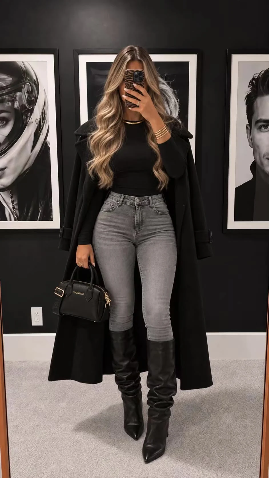 Woman wearing high-waisted jeans with knee boots and a wrap coat