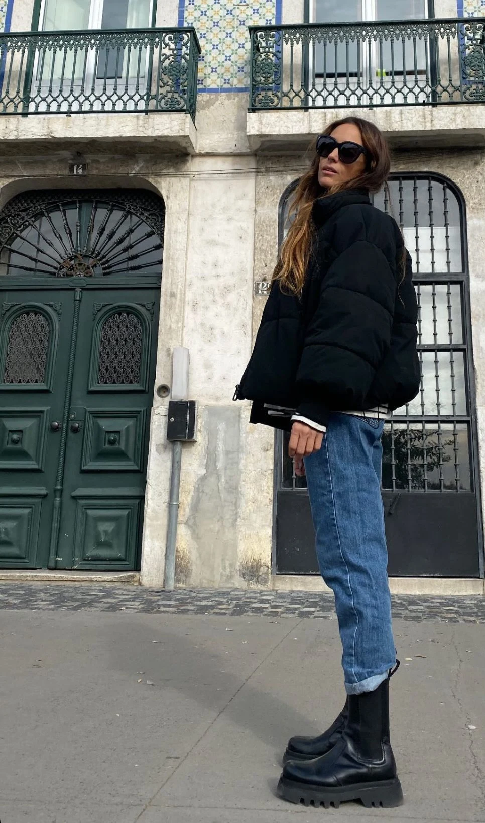 Woman wearing jeans with chunky lug boots and a puffer jacket in fall