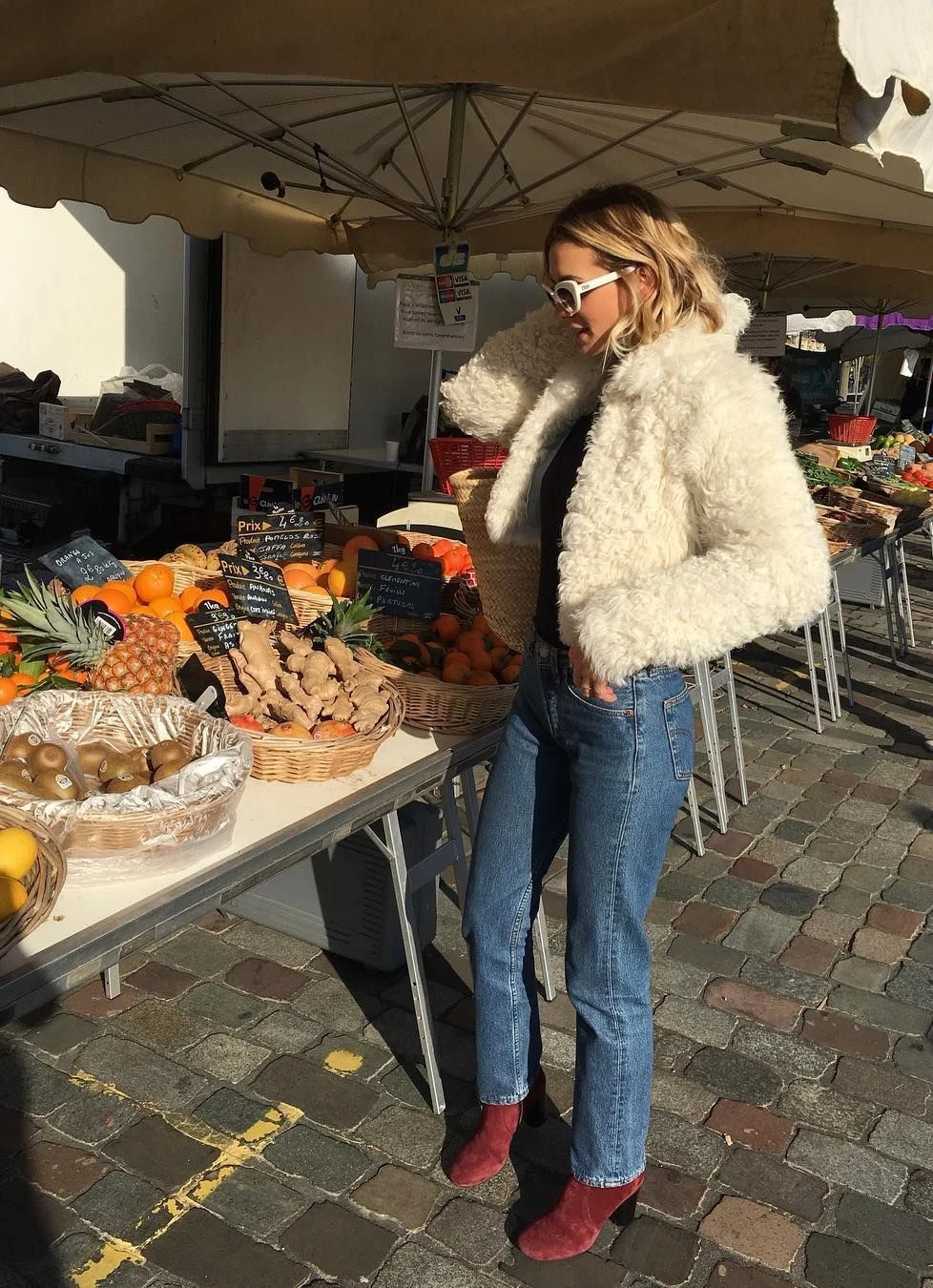 Woman wearing jeans with suede ankle boots and a teddy coat in fall