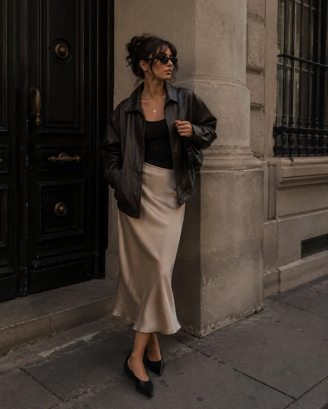 Black leather jacket with a satin midi skirt