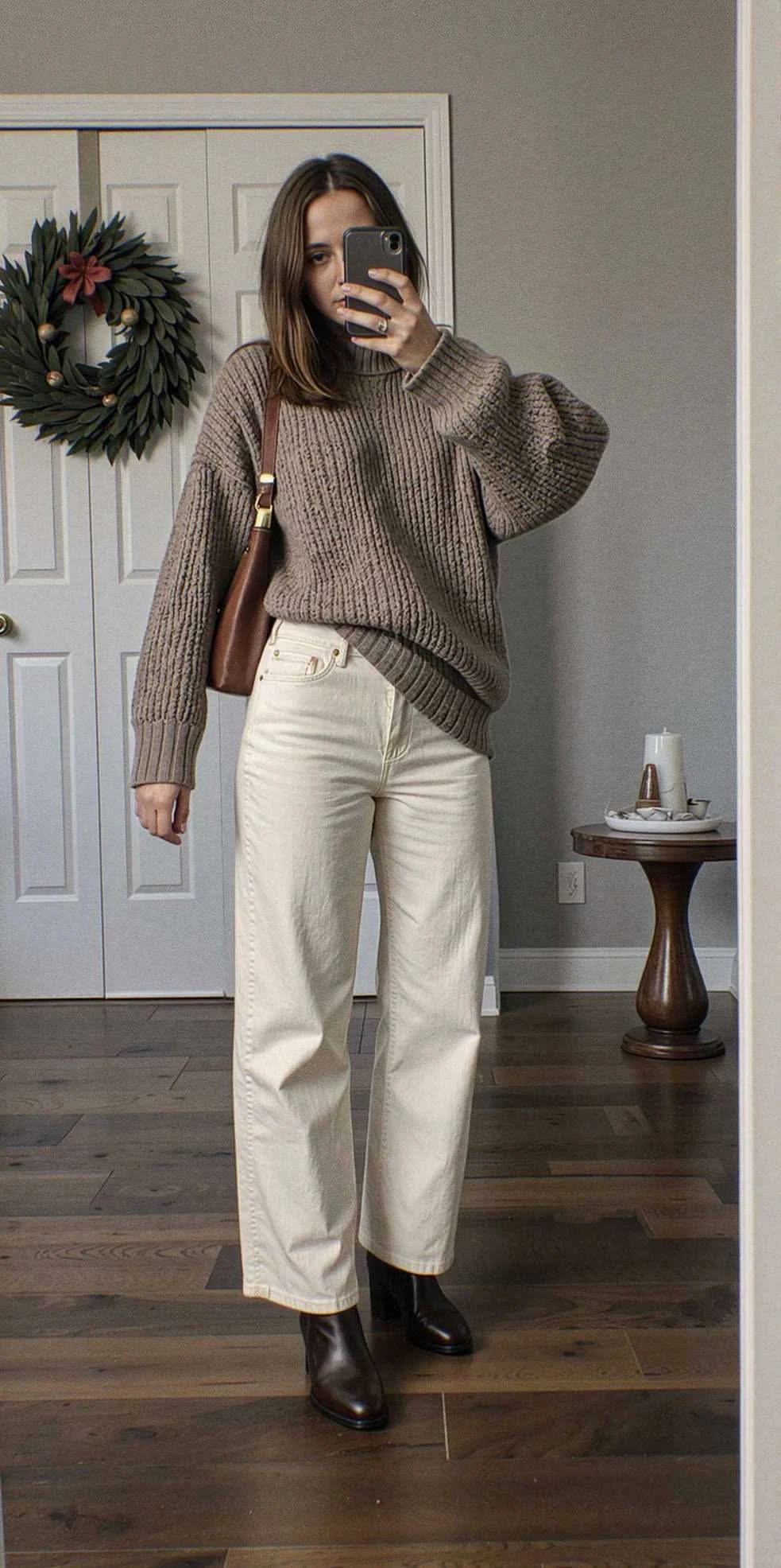 Cream chunky knit oversized sweater with straight jeans and ankle boots