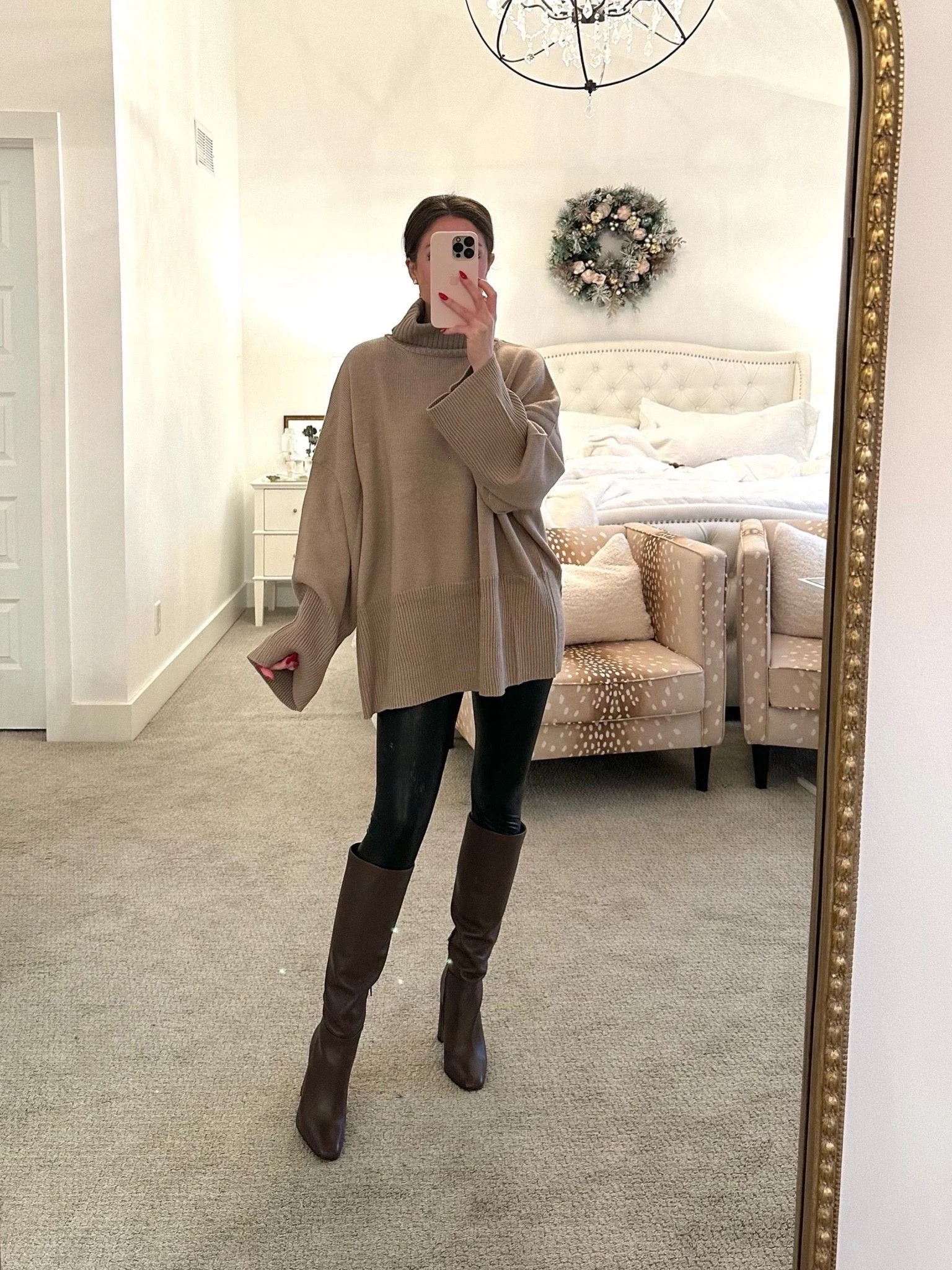 Camel oversized turtleneck sweater with black leggings and knee high boots