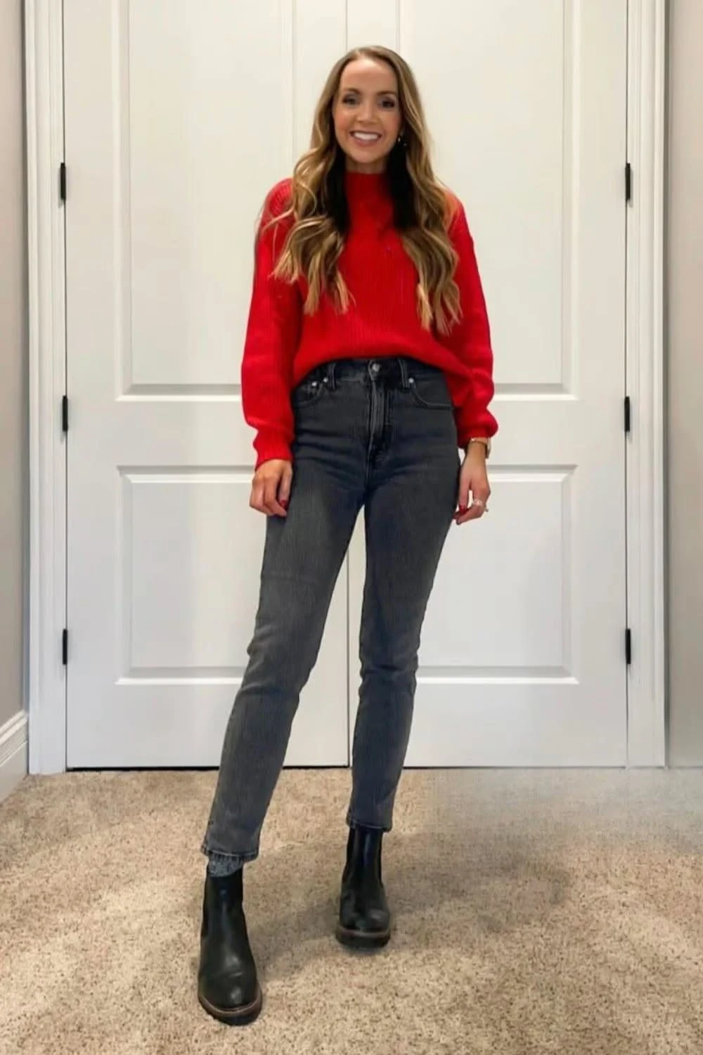 Red oversized sweater with black jeans and ankle boots