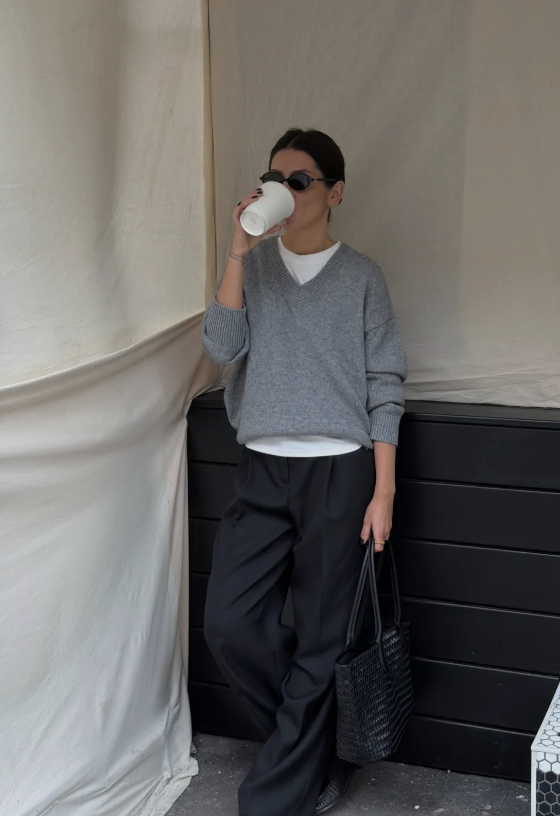 Oversized V neck sweater over collared shirt with trousers